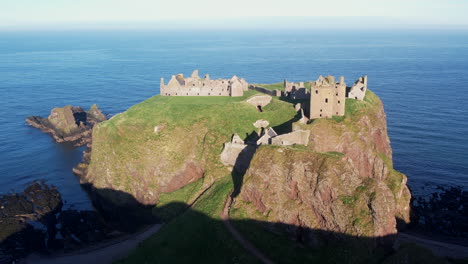 very-detailed-circular-drone-flight-with-a-wide-view-of-the-huge-rock-in-the-ocean-where-the-scottish-castle-of-dunnottar-was-build