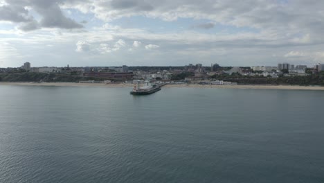 Low-wide-circling-drone-shot-of-Bournemouth-Pier