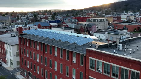 Solar-panel-arrays-collect-sunlight-for-green-renewable-energy-at-apartment-building