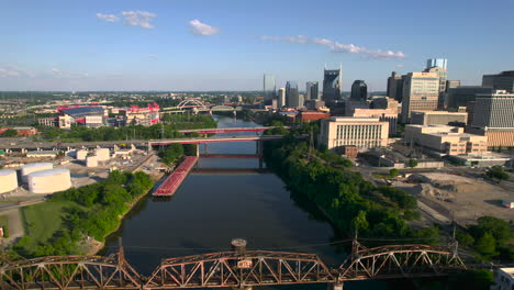 Aerial-view-flying-over-the-bridges-on-the-Cumberland-river,-golden-hour-in-Nashville,-USA