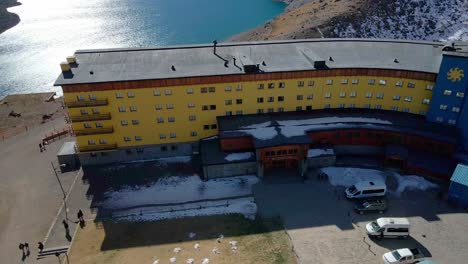 PORTILLO,-CHILE---MAY-15,-2022:-Aerial-orbit-of-the-Portillo-Hotel-between-the-border-between-Chile-and-Argentina-on-a-sunny-day