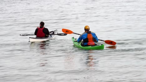 Group-of-males-kayak-training-team-exercise-in-Welsh-sea-recreational-pursuit