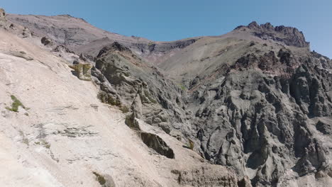 Aerial-Dolly-Back-Dry-Craggy-Cliffside-Edge-Landscape-Near-Cerro-Castillo