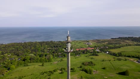 Aerial-view-of-a-radio-tower-in-Skamlebæk,-Odsherred-with-the-beautiful-coastline-of-Sejerøbugten,-Zealand,-Denmark