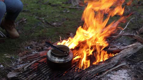 A-pot-boiling-water-over-a-fire-out-in-the-bush-in-the-Australian-high-country