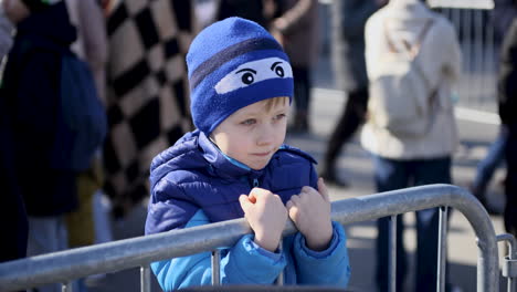 A-young-Ukrainian-boy-holds-the-railing-at-the-refugee-center-in-Warsaw