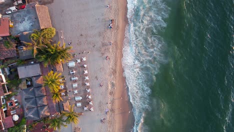 tropical-beachfront-hotels-and-resorts-at-Los-Muertos-Beach-at-sunset-in-Puerto-Vallarta-Mexico,-aerial-top-down