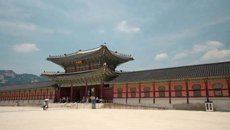 Distant-view-of-various-people-entering-Heungnyemun-Gate-in-Gyeongbokgung-Palace,-Seoul,-South-Korea