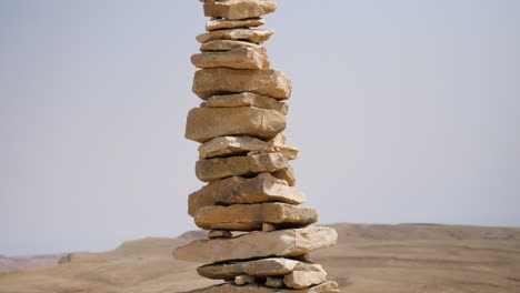 A-close-tilt-up-shot-of-stones-standing-on-top-of-each-other-in-the-form-of-towers-in-Ramon-Crater