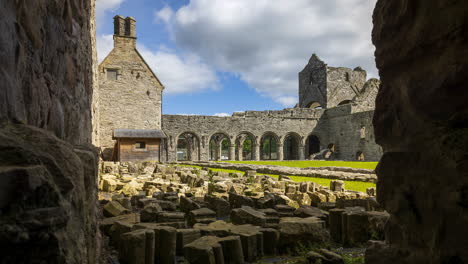 Motion-time-lapse-of-Boyle-Abbey-medieval-ruin-in-county-Roscommon-in-Ireland-as-a-historical-sightseeing-landmark-with-dramatic-clouds-in-the-sky-on-a-summer-day