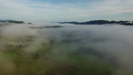 Costa-Rica-Landscape-Through-the-Clouds,-Aerial-Reveal-from-Above