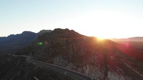 A-tilting-drone-shot-on-a-mountainous-road-at-sunset