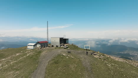 Drone-Flying-Towards-Ski-Lodge-On-Top-Of-Tskhratskaro-Pass,-Overlooking-Bakuriani-In-Borjomi-District-Of-Georgia