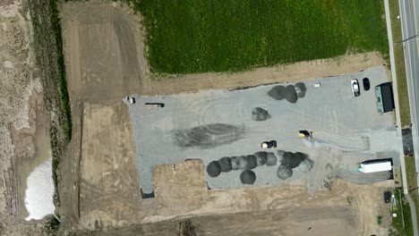 Top-down-aerial-over-construction-zone-area-laying-out-gravel-foundation