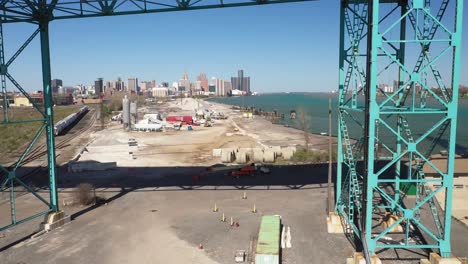 Ambassador-Bridge-connecting-Detroit,-Michigan-in-the-United-States-of-America-and-Windsor,-Ontario-in-Canada-drone-video-pulling-out-under-bridge