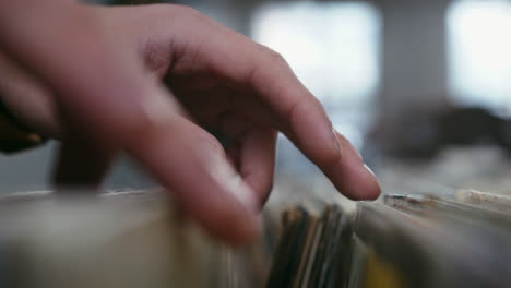 Male-hands-going-through-vinyl-records-collection,-close-up-view