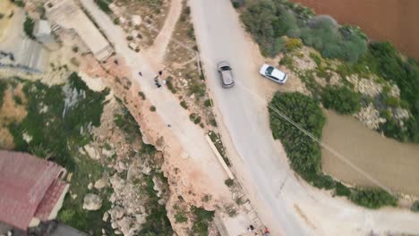 An-aerial-view-of-Coastal-Dirty-Road-where-cars-are-running-through-the-road