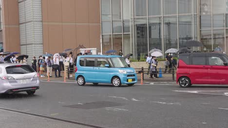 On-the-morning-after-Death-of-Former-PM-Shinzo-Abe,-People-Stand-in-rain-to-pay-respects-to-his-passing