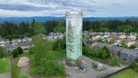 Aerial-shot-of-a-water-tower-surrounded-by-a-suburban-neighborhood