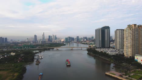 Drone-footage-of-Saigon-River-in-Ho-Chi-Minh-City-with-a-cargo-ship