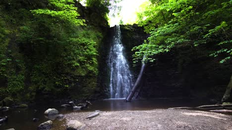 Wide-shot-of-a-waterfall-and-the-sky-surrounded-by-the-forest