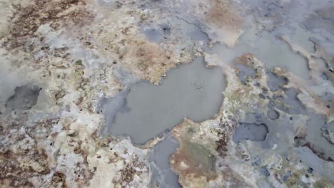 Aerial-view-tilt-up-over-Hverir-geothermal-area-with-boiling-water-in-Iceland