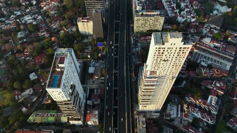 Highway-Interstate-Road-between-Two-Skyscrapers,-Segundo-Piso-Periférico-in-Mexico-City,-Aerial