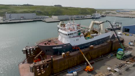 An-aerial-view-The-fishing-trawler-is-in-dry-dock-undergoing-repairs-and-painting-jobs-in-Hanstholm
