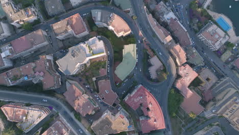 Aerial-top-down-overhead-footage-of-cars-driving-on-different-sections-of-a-hill-in-a-suburb-of-Naples,-Italy