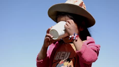 An-adorable-girl-at-a-rural-school-in-the-Andes-Mountains-drinking-from-a-mug