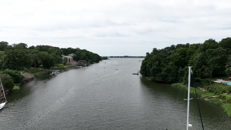 An-aerial-view-over-the-Saugatuck-River-in-Westport,-Connecticut-on-a-cloudy-day