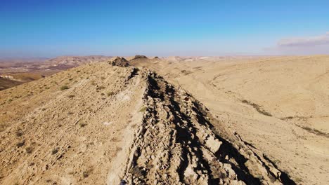 Aerial-Flying-Over-Male-Hiker-Walking-Along-Ridge-Line-In-The-Negev-Desert-Located-In-Israel