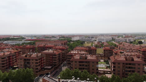 Ascend-over-apartment-building-neighborhood-in-Madrid,-aerial-view