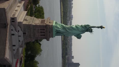Aerial-view-around-the-Statue-of-Liberty,-in-NYC,-USA---Vertical,-orbit,-drone-shot