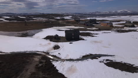 Drone-video-of-an-old-mining-site-in-a-snowy-Norwegian-landscape-was-captured-in-Røros,-Storwartz