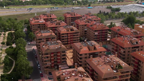 Rooftops-of-apartment-building-district-in-Spain,-aerial-orbit-view
