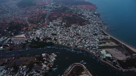 Aerial-drone-view-of-overpopulated-coastal-Phan-Thiet-Vietnamese-city-at-dusk