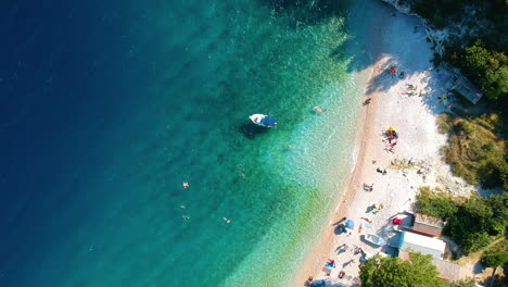 People-Swimming-On-The-Clear-Water-Sea-During-Summer-In-Croatia