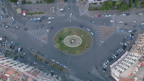 Slow-aerial-top-down-overhead-footage-of-roundabout-in-a-neighborhood-just-outside-of-Naples,-Italy