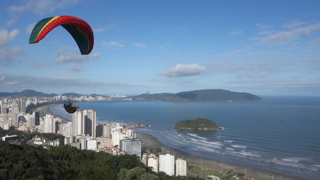 Paraglider-with-colourful-wing-canopy-flies-low-past-launch-site