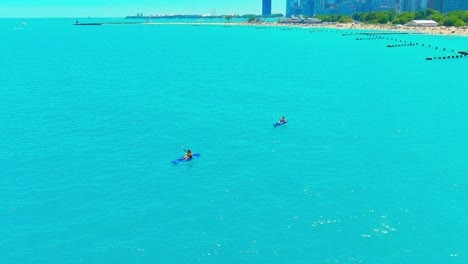 Aerial-flyby-of-people-kayaking-at-North-Avenue-beach-in-Chicago-Illinois-|-Afternoon-Lighting
