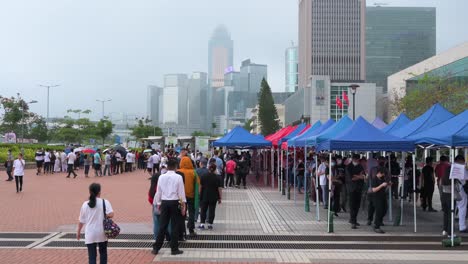 People-queue-in-line-to-receive-PCR-tests-for-coronavirus-from-a-Community-Testing-Centre-truck-to-tackle-the-spread-of-the-virus-and-a-pandemic-wave-near-Hong-Kong's-financial-district