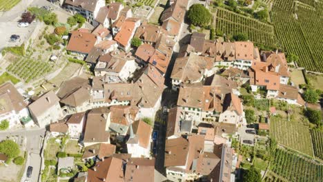 Drone-following-car-through-Riex-village,-Lavaux---Switzerland