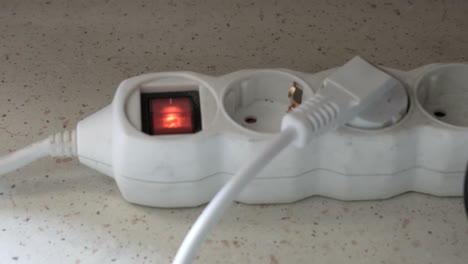 Turn-electricity-on-a-switch-of-an-electric-extension-cord