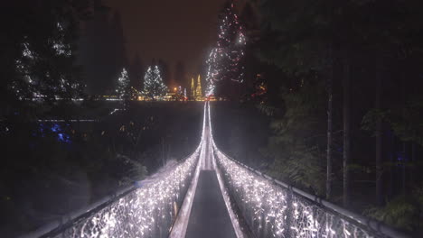 Wide-shot-of-Suspension-bridge-decorated-with-Christmas-lights,-Rainy-night