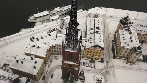 Establishing-aerial-view-of-beautiful-Riddarholmen-and-neighbouring-port-in-Stockholm-city-centre-during-wonderful-winters-day