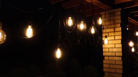 hanging-light-bulbs-with-yellow-orange-glowy-light-at-night