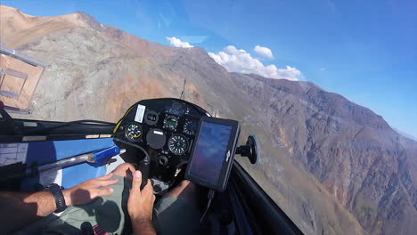 Glider-filmed-from-the-inside-while-flying-close-to-the-mountains,-in-Ful-HD-at-60-fps