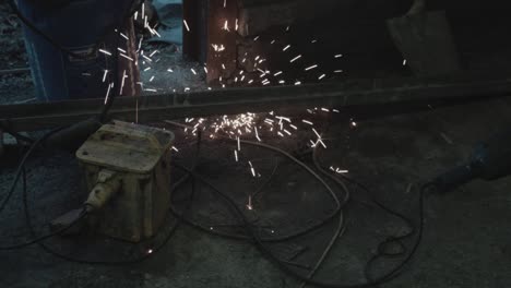 Welding-sparks-hitting-ground-in-garage-floor