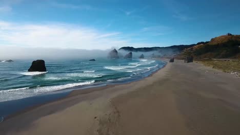 AERIAL:-Flyover-of-an-Oregon-beach-as-waves-crash-into-the-sand